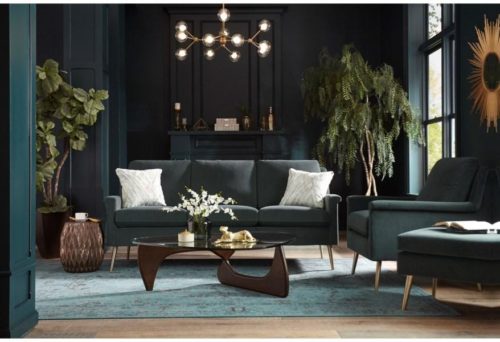 Dark green sofa by Best Home Furnishings pulling the moody home design together.