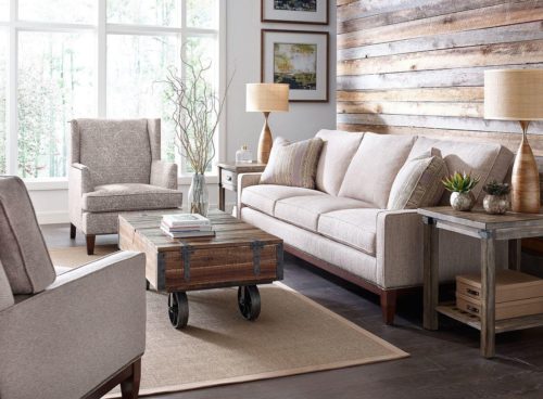 Brown, industrial decorative coffee table cart placed in a beautiful living room.