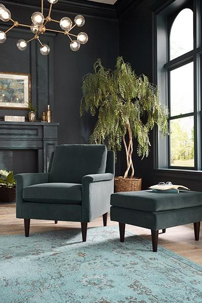 Charcoal grey velvet accent chair and ottoman.