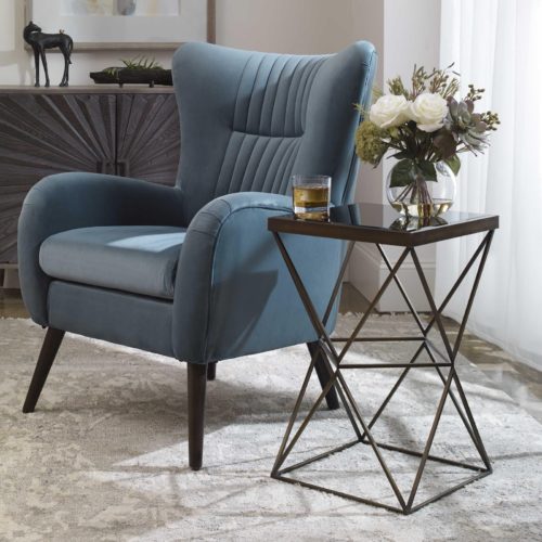 fun accent table next to blue accent chair by Uttermost